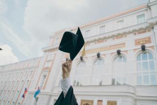 a person holding a black umbrella by RUT MIIT courtesy of Unsplash.