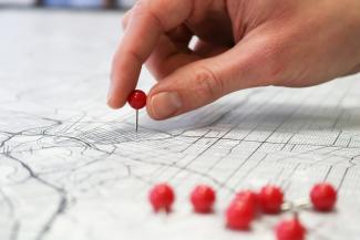 person holding red round medication pill by GeoJango Maps courtesy of Unsplash.