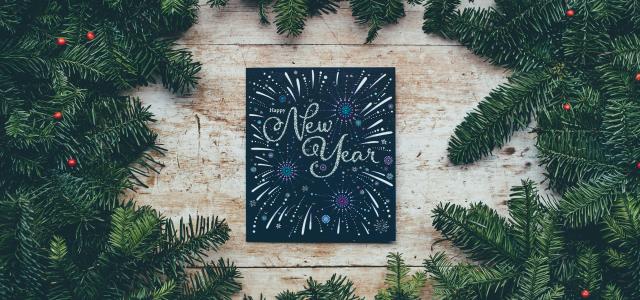 green Christmas decor with New Year greetings by Annie Spratt courtesy of Unsplash.