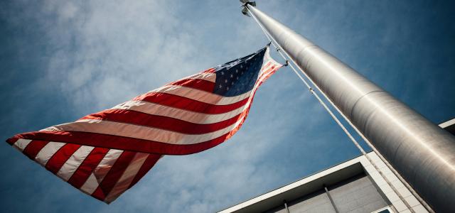low-angle photo of U.S. flag placed on gray pole by Jonathan Simcoe courtesy of Unsplash.