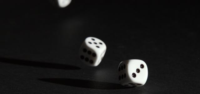 3 white dice on black surface by Alois Komenda courtesy of Unsplash.